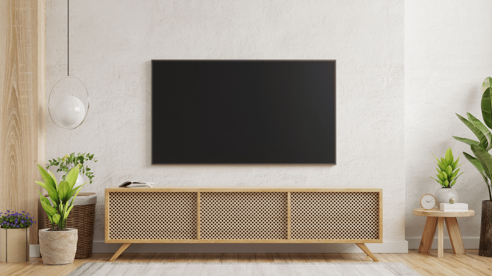 Modern living room with a sleek wall-mounted TV and stylish wooden console, highlighting professional TV mounting services.