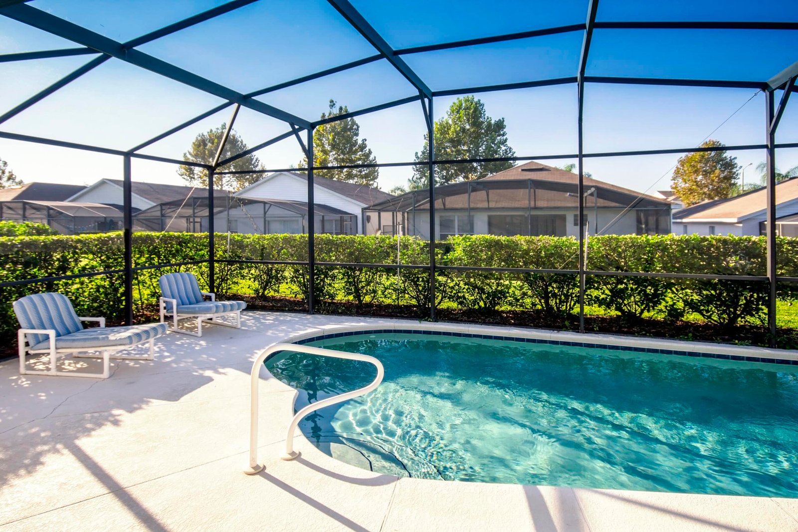 Outdoor patio with a high-quality screened enclosure, providing shade and protection from insects – Handy Hive Pros patio screen installation service.